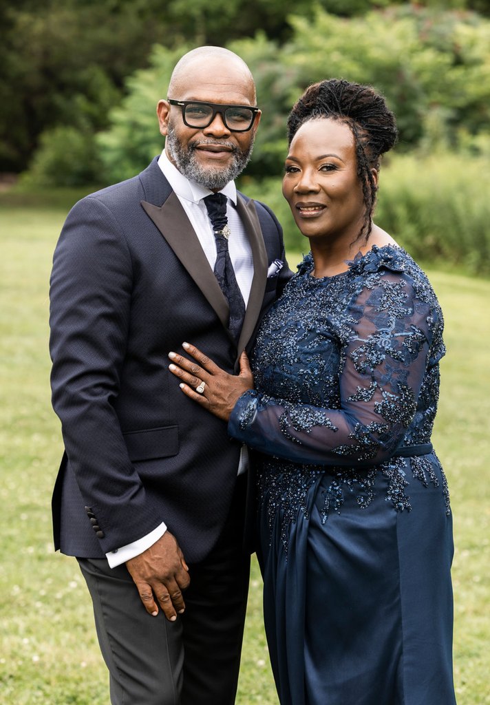 Bishop Robert Francis and Rev. Marie Francis standing together in formal dress on a lawn